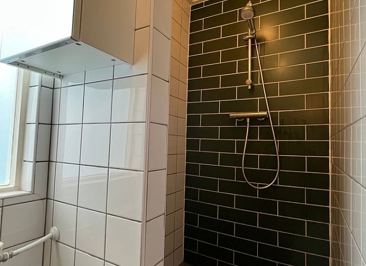 Cozy kitchen in cottage Ruinerwold, Southwest Drenthe, with wooden beams and modern amenities.