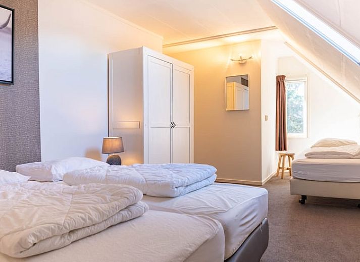 Cozy kitchen in cottage Ruinerwold, Southwest Drenthe, with wooden beams and modern amenities.