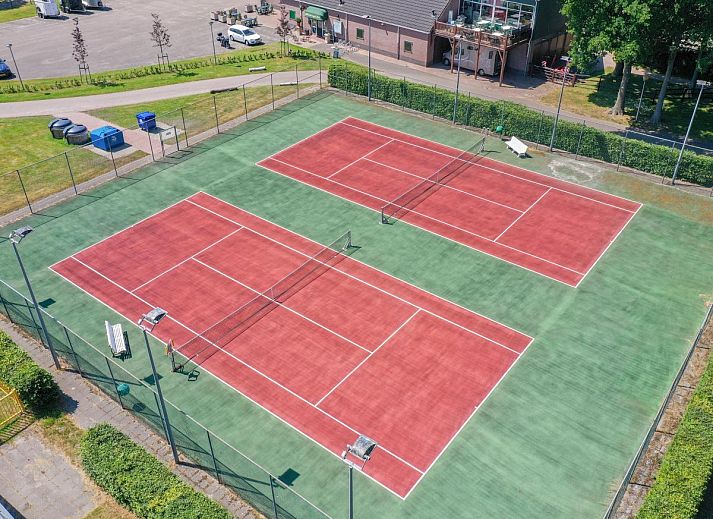 Gezellige slaapkamer in chalet Onderduikershol, Zorgvlied, Zuidwest Drenthe, met comfortabel bed en rustgevend uitzicht op de natuur.