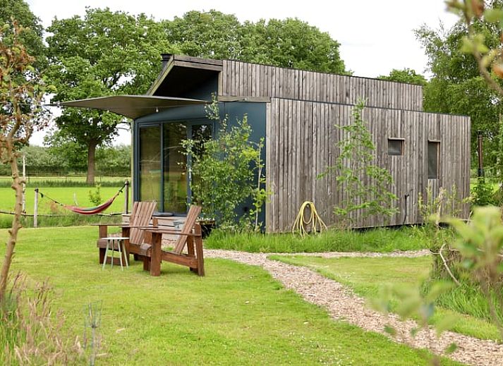 Cottage in Vledder at dusk, Southwest Drenthe, with atmospheric outdoor lighting.