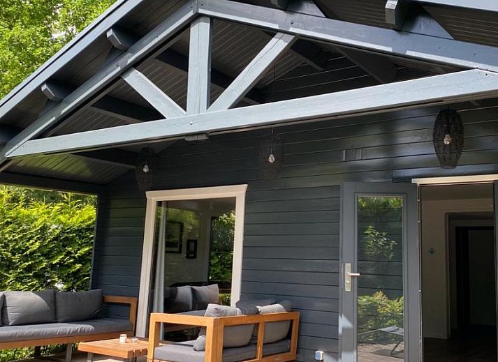 Charming bungalow Cottage 54 in Wateren, Drenthe, surrounded by green nature and an inviting terrace.