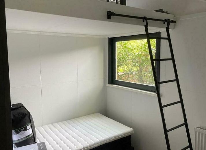 Modern living room of Cottage 54 in Wateren, Drenthe, with comfortable sofas and plenty of natural light.