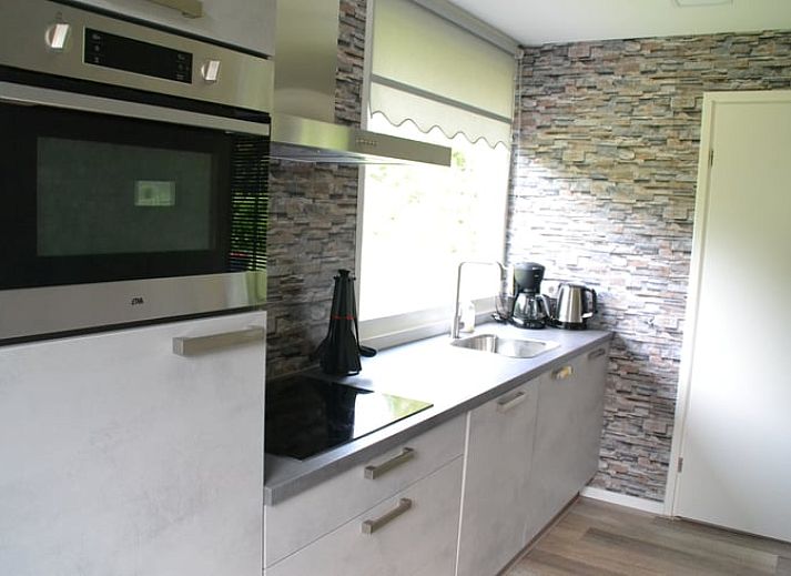 Atmospherically lit patio in Holiday Home in Wittelte, Southwest Drenthe, for evening meals outside.