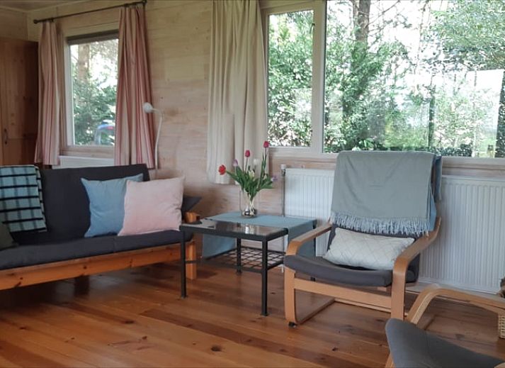 Front view of Cottage in Koekange, vacation home in Southwest Drenthe, surrounded by lush green garden.