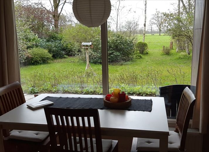Front view of Cottage in Koekange, vacation home in Southwest Drenthe, surrounded by lush green garden.
