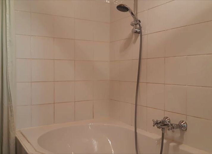 Cozy porch of Huisje in Koekange, cottage in Southwest Drenthe, with tea and garden views.