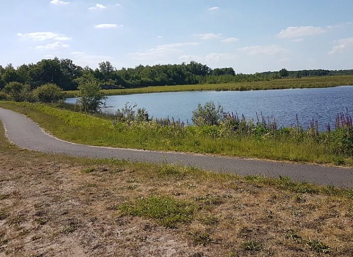 Diele des Ferienhauses in Tiendeveen, Drenthe mit Holztreppe und natuerlichem Licht.