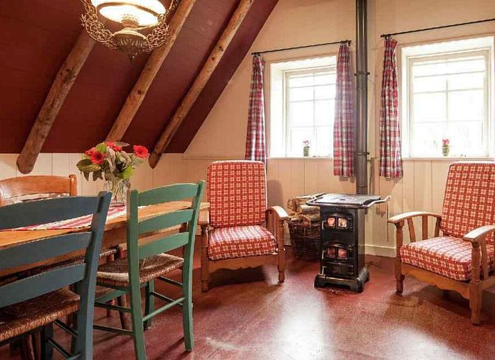 Gemuetliches Esszimmer im Ferienhaus DG613 in Ansen, Drenthe mit Holzinterieur.