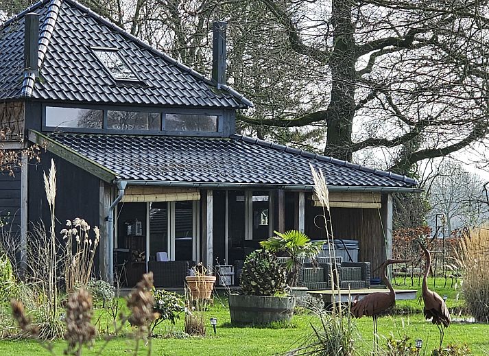 Aerial view of DG2027, a charming vacation home in Dieverbrug, Southwest Drenthe, surrounded by green fields and rustic nature.
