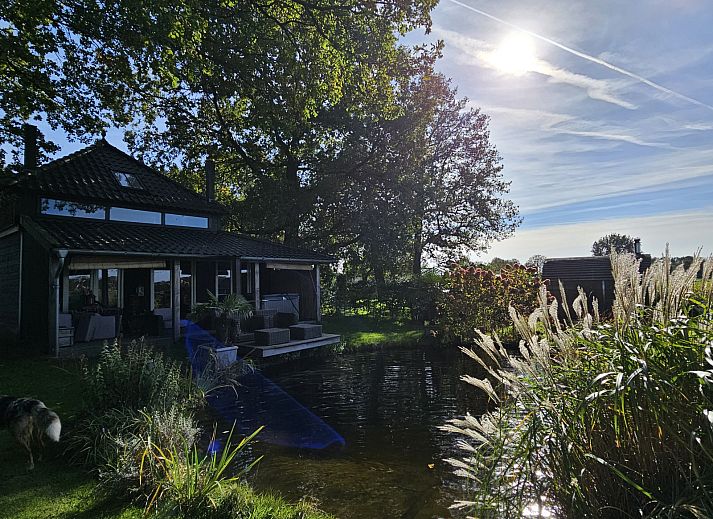 Aerial view of DG2027, a charming vacation home in Dieverbrug, Southwest Drenthe, surrounded by green fields and rustic nature.