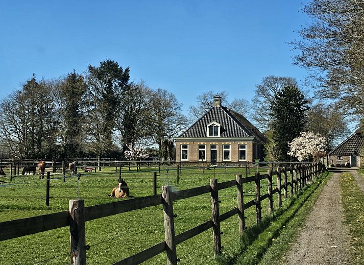 Aerial view of DG2027, a charming vacation home in Dieverbrug, Southwest Drenthe, surrounded by green fields and rustic nature.