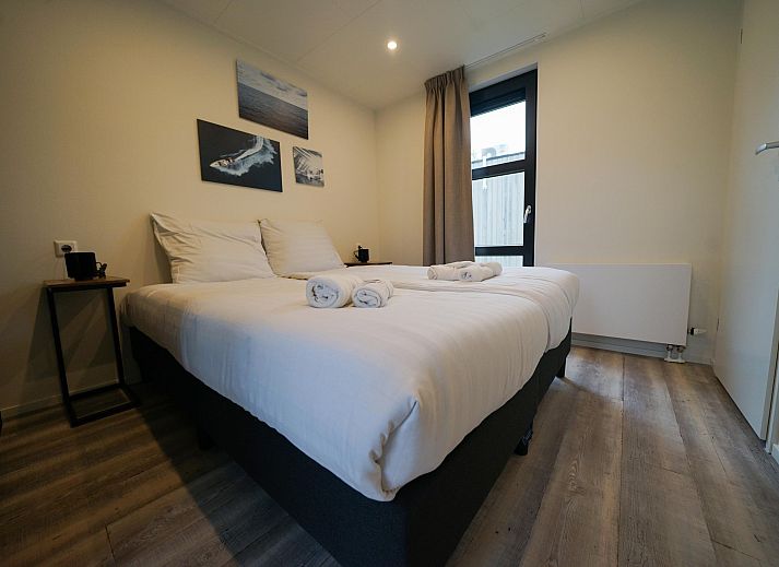 Bright living room of detached house in Biddinghuizen, vacation home in Eastern Flevoland with expansive views of the green surroundings.