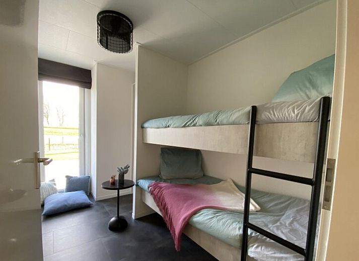 Modern living room of detached house in Biddinghuizen, vacation home in Flevoland with comfortable seating area and view of the garden.