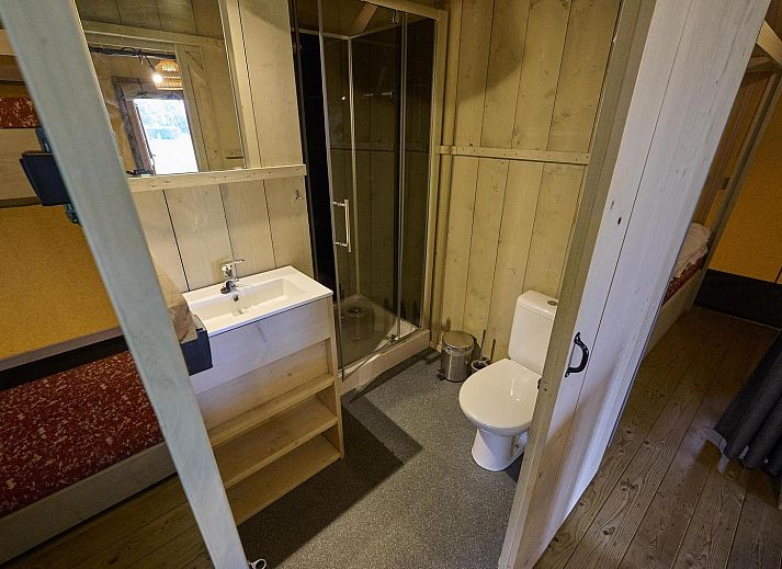 Comfortable interior of Safari Tent Wood in Biddinghuizen with sitting area and plenty of natural light in Flevoland.