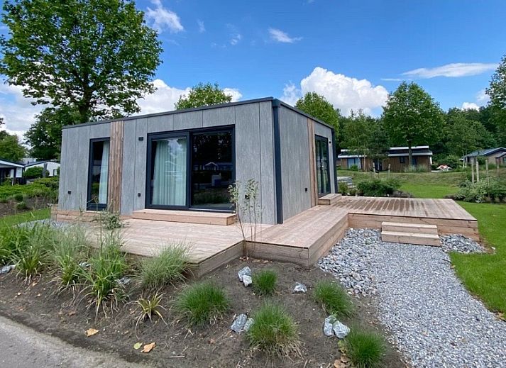 Chalet in Biddinghuizen, vakantiehuis in Oostelijk Flevoland met moderne buitenkant en houten terras.