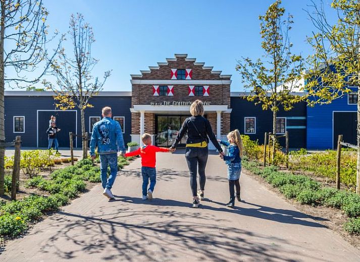Stijlvolle eetruimte in Vakantiehuis Cube Elite 6, Biddinghuizen, Flevoland met grote houten tafel en moderne keuken.