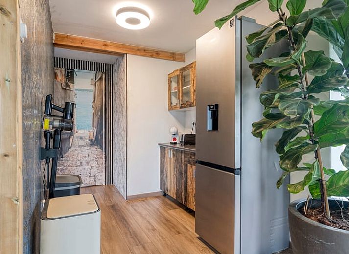 Cozy outdoor area of cottage in Dronten at dusk, with terrace and garden in Eastern Flevoland, ideal for evenings outside.