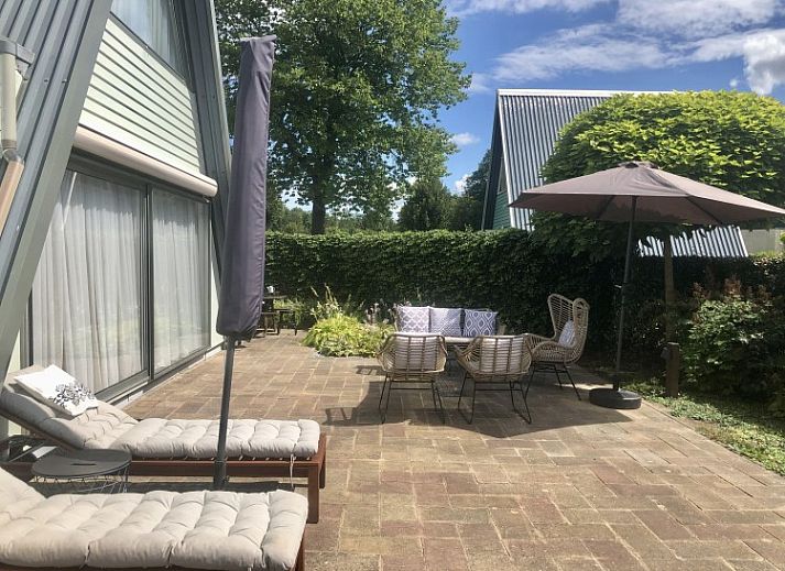 Terrace of A76 vacation home in Zeewolde, Southern Flevoland with comfortable sunbeds and seating area.