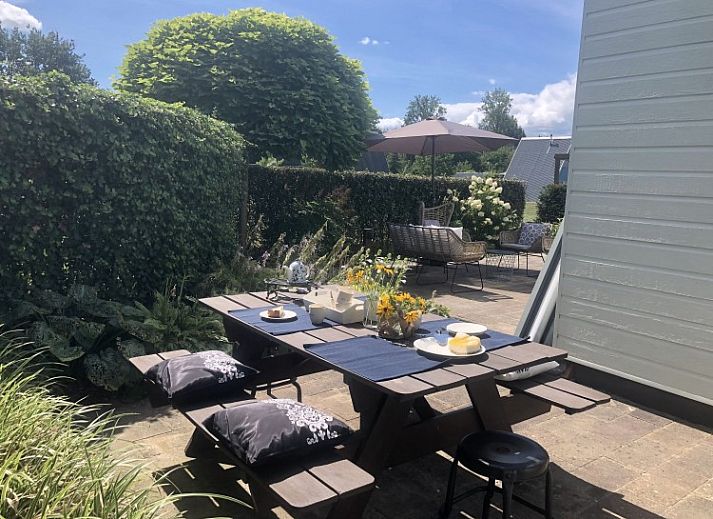 Terrace of A76 vacation home in Zeewolde, Southern Flevoland with comfortable sunbeds and seating area.