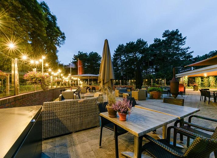 Gezellige woonkamer met uitzicht op het terras bij WestCord ApartHotel Boschrijck, West-Terschelling.