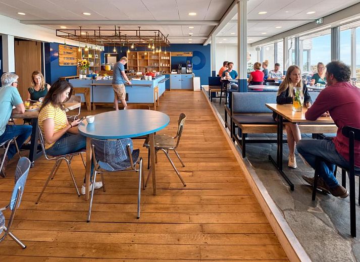 Cozy dining area in Stayokay Hostel Terschelling overlooking the nature of West Terschelling.