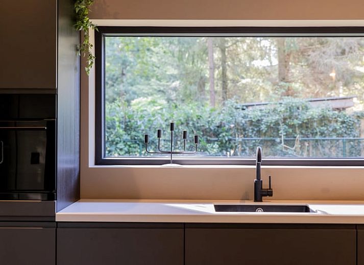 Relax on the porch of Huisje in Appelscha, a vacation home in the Frisian woods, Friesland, with a view of nature.