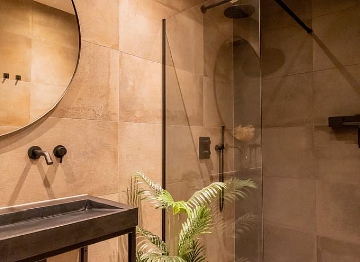 Stylish living room of a cottage in Appelscha, vacation home in the Frisian forests, Friesland, with modern furnishings and art on the walls.
