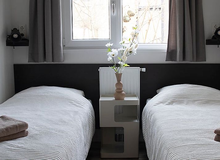 Vacation home in Oosterwolde, located in the Frisian forests of Friesland, with a wooden terrace and surrounded by green nature.