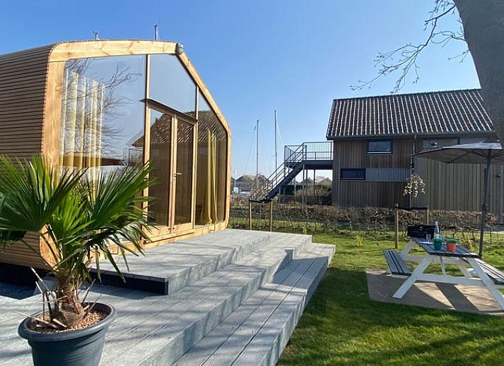 Cozy interior of Holiday home in Stavoren with bright decor and garden view, perfect for a vacation in Friesland.