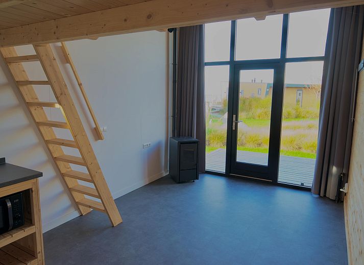 Vrijstaande woning in Hindeloopen, een modern vakantiehuis in Friesland met ruime ramen en omgeven door groene natuur.