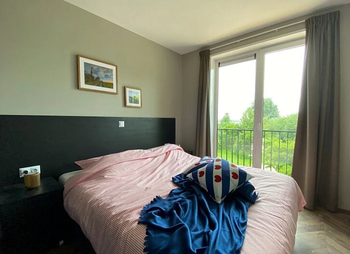 Stylish living room in the detached house in Hindeloopen, Friesland, with modern interior and views of green surroundings.