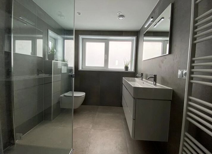 Stylish living room in the detached house in Hindeloopen, Friesland, with modern interior and views of green surroundings.