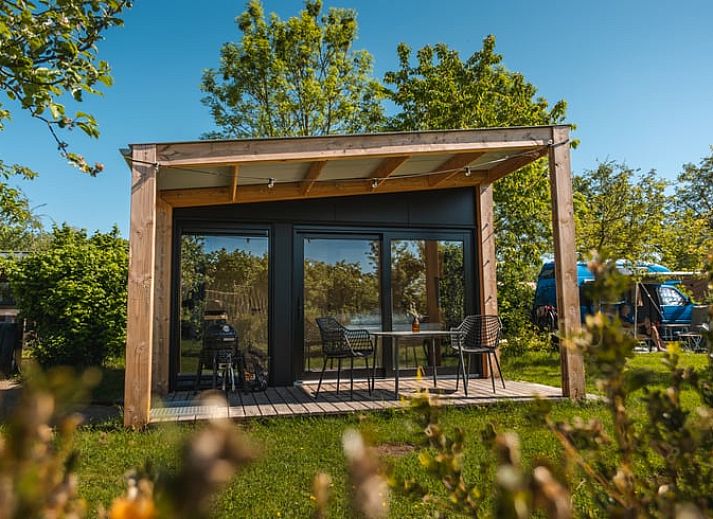 Vacation home with spacious veranda in Scherpenzeel, amidst the Frisian greenery.