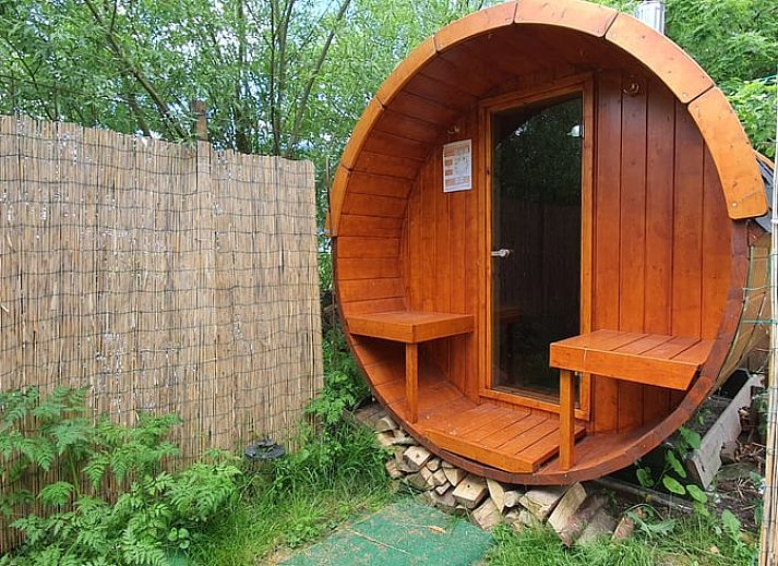 Ferienhaus in Easterein mit Baumhaus und Beschilderung in einem bewaldeten Gebiet in Friesland.