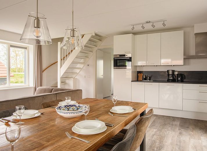 Cozy living room of Watervilla Snoek, a modern bungalow in Langelille, Friesland, overlooking the Frisian countryside.