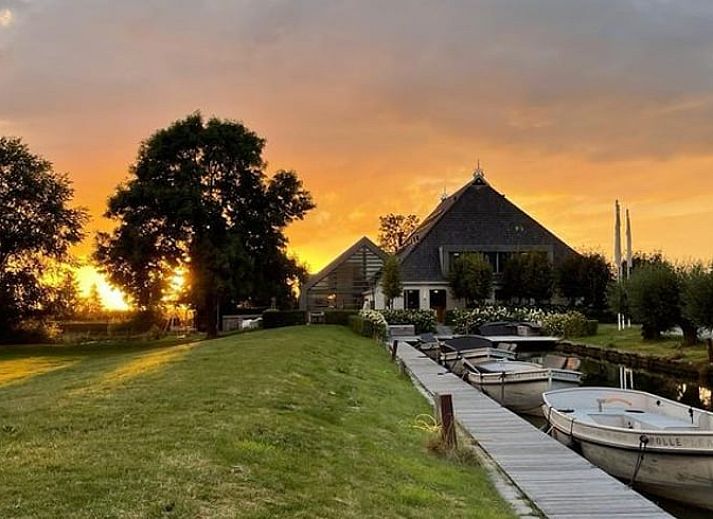 Houten eettafel in Vakantiehuisje in Westhem met panoramisch uitzicht op het Friese platteland, Friesland.