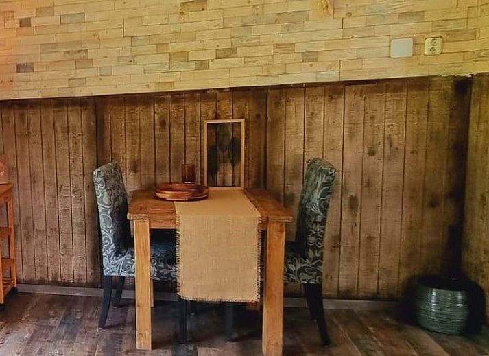 Cozy terrace at Holiday home in Bantega, Friesland, overlooking the countryside at sunset.