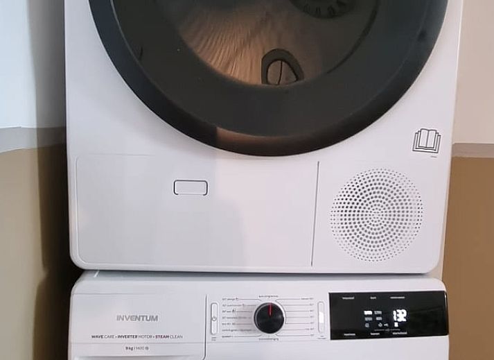 Comfortable chairs in the garden of Holiday Home in Bantega, Friesland, overlooking green meadows.