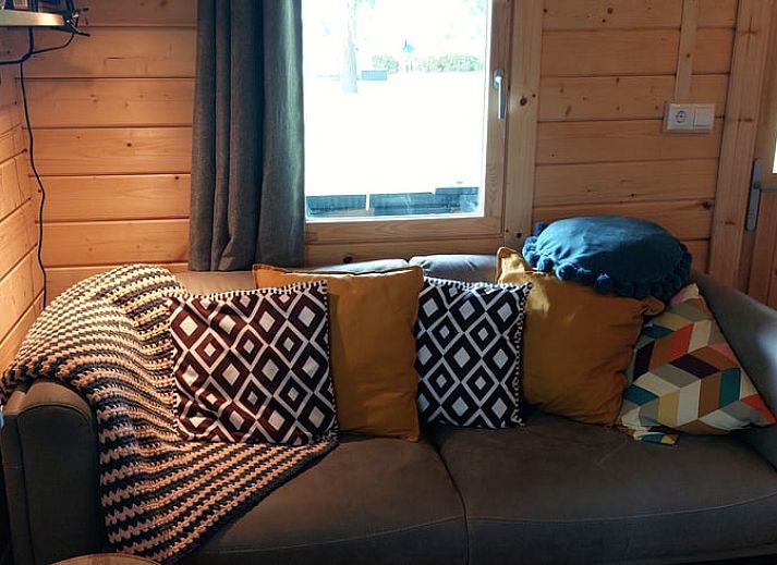 Porch of cottage in Munnekeburen overlooking lush fields in Friesland.