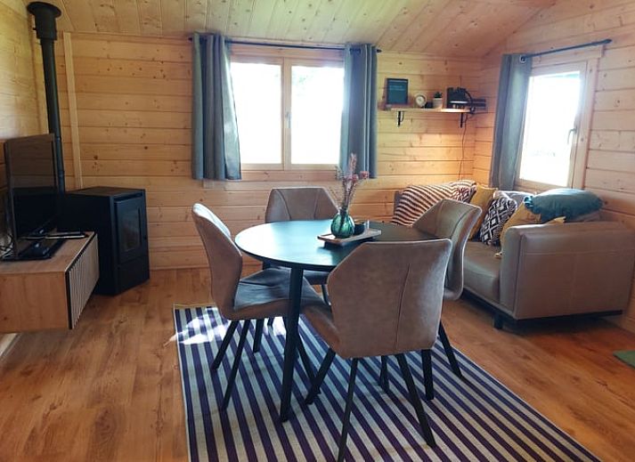 Porch of cottage in Munnekeburen overlooking lush fields in Friesland.