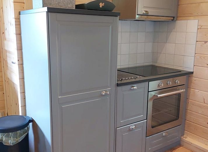 Porch of cottage in Munnekeburen overlooking lush fields in Friesland.