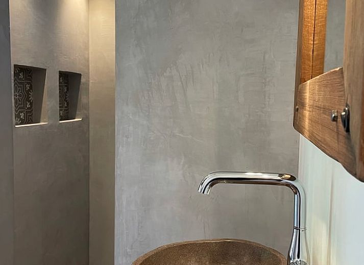 Cozy living room of vacation home Cottage in Goenga overlooking the Frisian countryside.