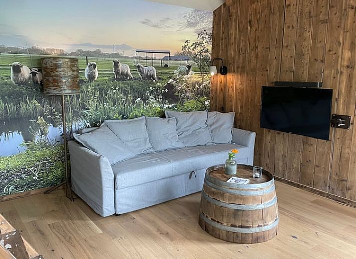 Cozy living room of vacation home Cottage in Goenga overlooking the Frisian countryside.