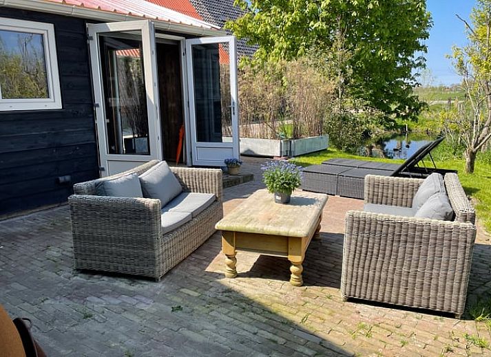 Cozy living room of vacation home Cottage in Goenga overlooking the Frisian countryside.
