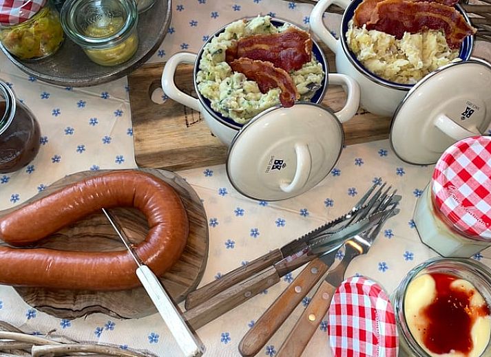 Classic red car parked at vacation home Cottage in Goenga in the Frisian countryside.