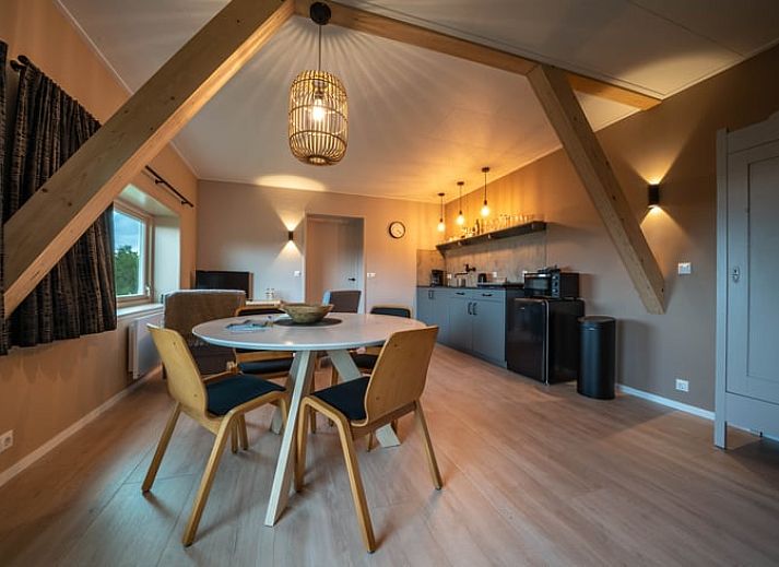 Rustieke omgeving van Huisje in Bears, vakantiehuis op het Friese platteland, met weelderige natuur en serene waterloop in Friesland.