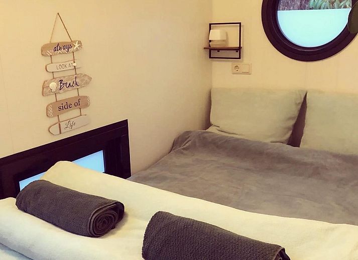 Cozy interior of The White Houseboat in Lathum, Gelderland. Perfect vacation home for two with modern kitchen and cozy interior.