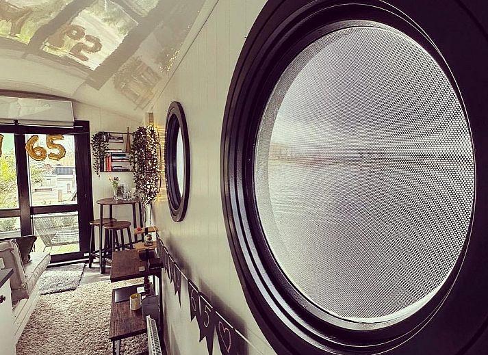 Cozy interior of The White Houseboat in Lathum, Gelderland. Perfect vacation home for two with modern kitchen and cozy interior.