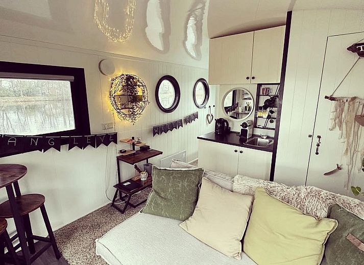 Cozy interior of The White Houseboat in Lathum, Gelderland. Perfect vacation home for two with modern kitchen and cozy interior.