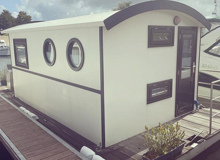 Attractive bedroom in The White Houseboat, a unique vacation accommodation for 2 persons in Lathum, Rivierengebied, Gelderland.